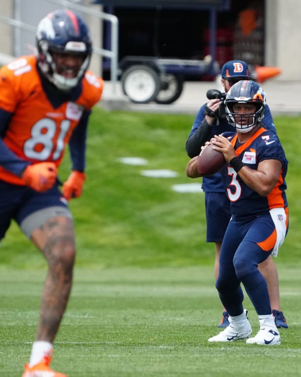 Denver Broncos quarterback Russell Wilson (3) drops back to pass during OTA workouts at the UC Health Training Center.