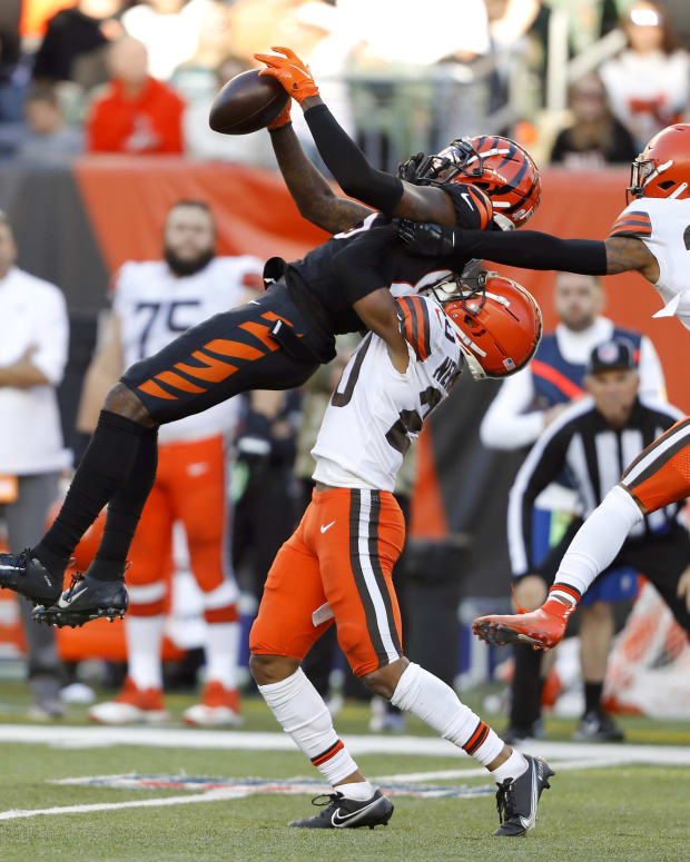Nov 7, 2021; Cincinnati, Ohio, USA; Cincinnati Bengals wide receiver Tee Higgins (85) fights for the ball with Cleveland Browns defensive back Grant Delpit (22) and cornerback Greg Newsome II (bottom) during the fourth quarter at Paul Brown Stadium. Mandatory Credit: Joseph Maiorana-USA TODAY Sports