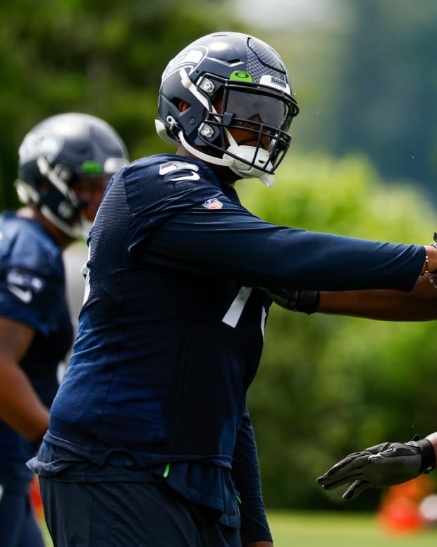 Seattle Seahawks tackle Greg Eiland (75, left) and offensive tackle Charles Cross (67, right) participate in a drill during minicamp practice at the Virginia Mason Athletic Center Field.