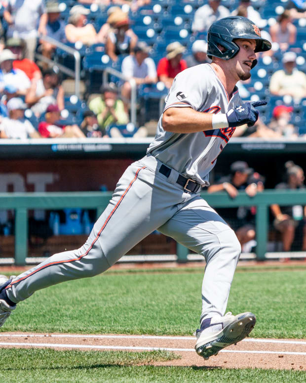 Jun 20, 2022; Omaha, NE, USA; Auburn Tigers second baseman Cole Foster (7) runs past first base after hitting a double against the Stanford Cardinal during the second inning at Charles Schwab Field. Mandatory Credit: Dylan Widger-USA TODAY Sports