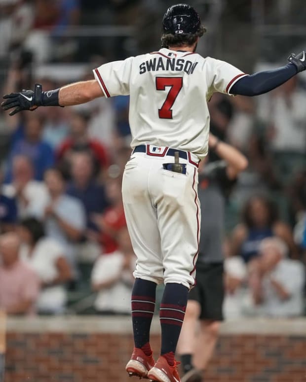 Jun 22, 2022; Cumberland, Georgia, USA; Atlanta Braves shortstop Dansby Swanson (7) reacts after hitting a home run against the San Francisco Giants during the ninth inning at Truist Park. Mandatory Credit: Dale Zanine-USA TODAY Sports