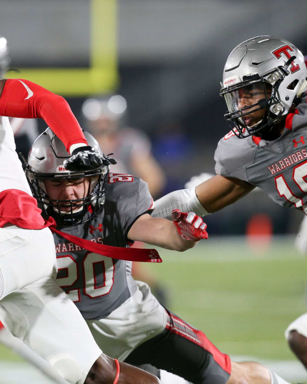 Thompson linebacker Kendall Franklin LB (20) and Thompson linebacker Seth Hampton (18) work to tackle Central wide receiver Karmello English (2) during the 7A state championship game in Birmingham Wednesday, Dec. 1, 2021. [Staff Photo/Gary Cosby Jr] 7a Championship Central Vs Thompson