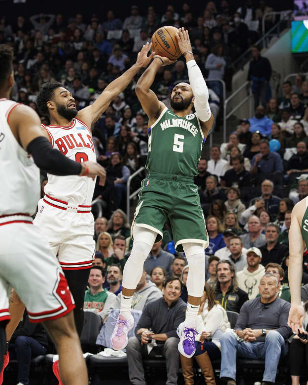 Apr 27, 2022; Milwaukee, Wisconsin, USA; Milwaukee Bucks guard Jevon Carter (5) shoots against Chicago Bulls guard Coby White (0) during the second quarter during game five of the first round for the 2022 NBA playoffs at Fiserv Forum.