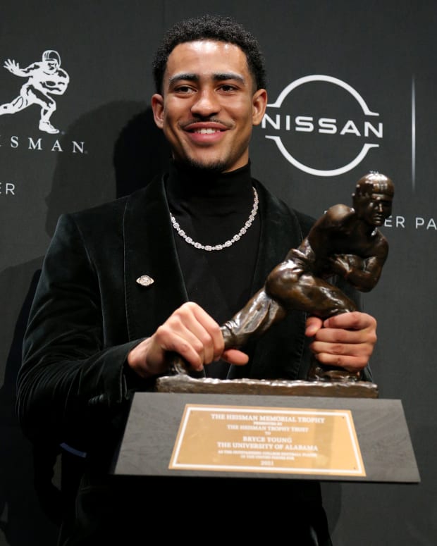 Bryce Young holding the Heisman Trophy.