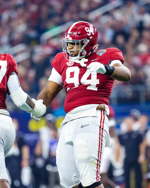 Alabama Crimson Tide defensive lineman DJ Dale (94) celebrates with defensive lineman Byron Young (47) after making a sack during the first half against the Cincinnati Bearcats in the 2021 Cotton Bowl college football CFP national semifinal game at AT&T Stadium.