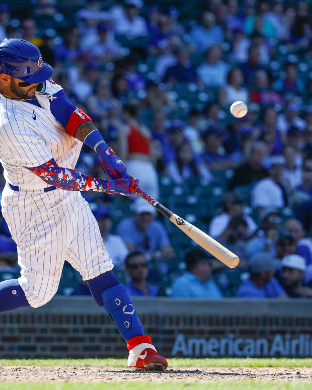 Jun 16, 2022; Chicago, Illinois, USA; Chicago Cubs second baseman Jonathan Villar (24) triples against the San Diego Padres during the ninth inning at Wrigley Field.