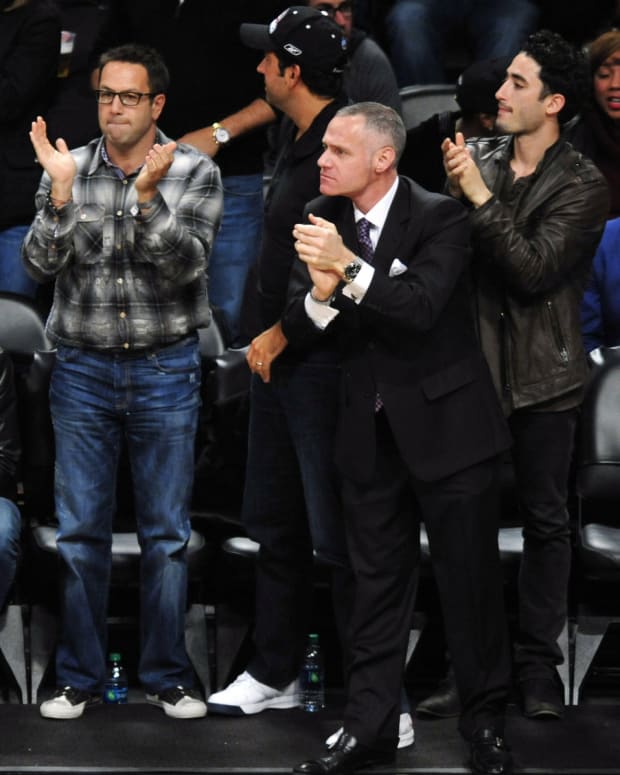 May 4, 2013; Brooklyn, NY, USA; Brooklyn Nets CEO Brett Yormark (center) cheers against the Chicago Bulls during the second half in game seven of the first round of the 2013 NBA Playoffs at the Barclays Center. The Bulls won 99-93.