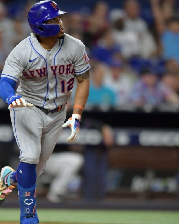 Jun 24, 2022; Miami, Florida, USA; New York Mets shortstop Francisco Lindor (12) hits a double in the sixth inning that scored three runs against the Miami Marlins at loanDepot Park. Mandatory Credit: Jim Rassol-USA TODAY Sports