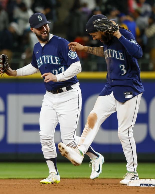 Jun 28, 2022; Seattle, Washington, USA; Seattle Mariners left fielder Jesse Winker (27) and shortstop J.P. Crawford (3) celebrate following a 2-0 victory against the Baltimore Orioles at T-Mobile Park. Mandatory Credit: Joe Nicholson-USA TODAY Sports