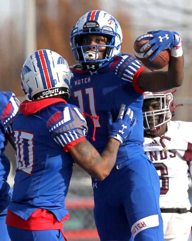 Hutchinson's Malik Benson (11) celebrates after hauling in a Hail Mary touchdown with Cortez Braham (1) and Demariyon Houston (10) during the Salt City Bowl against Hinds Community College Saturday, Dec. 4, 2021, at Gowans Stadium.