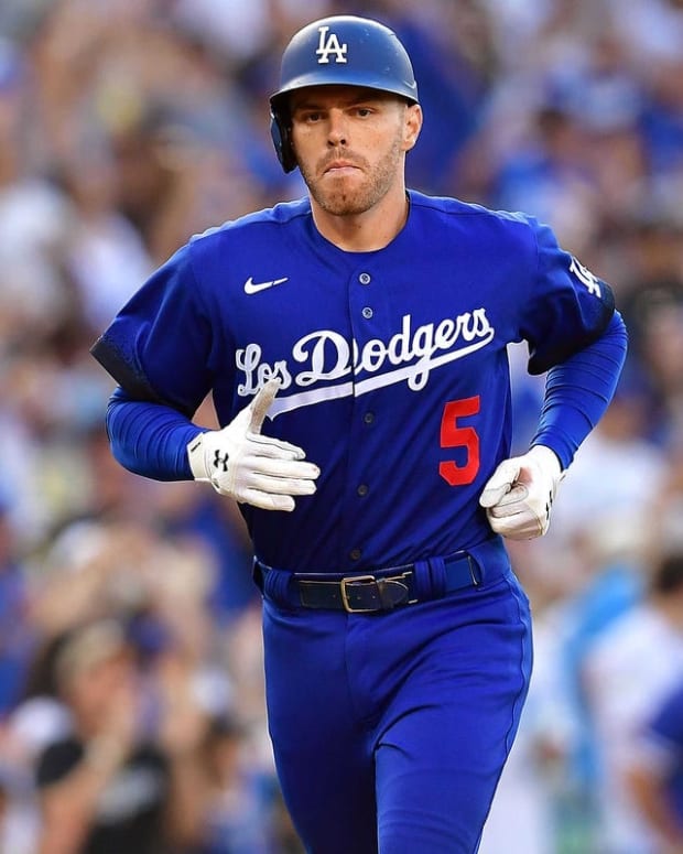 Jul 23, 2022; Los Angeles, California, USA; Los Angeles Dodgers first baseman Freddie Freeman (5) reaches home after hitting a solo home run against the San Francisco Giants during the seventh inning at Dodger Stadium. Mandatory Credit: Gary A. Vasquez-USA TODAY Sports