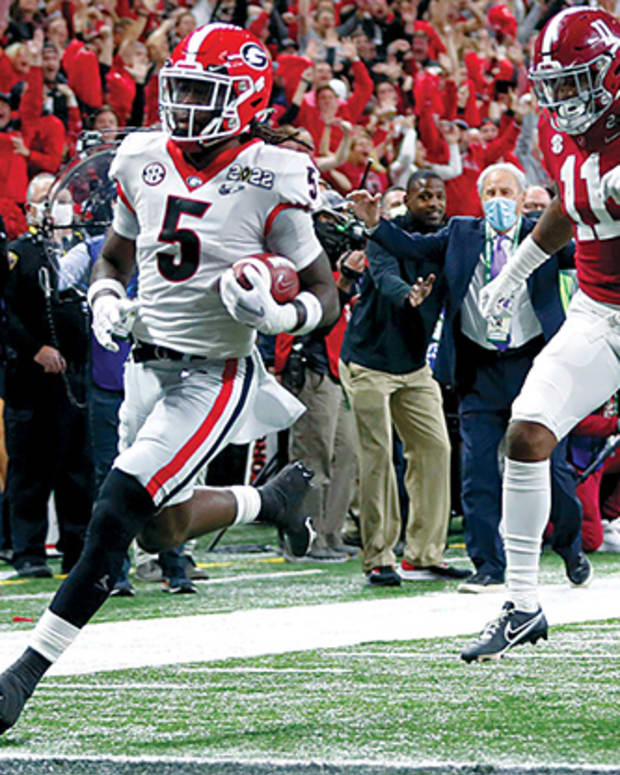 Georgia Bulldogs defensive back Kelee Ringo (5) returns a interception for a touchdown during the College Football Playoff National Championship at Lucas Oil Stadium in Indiana.