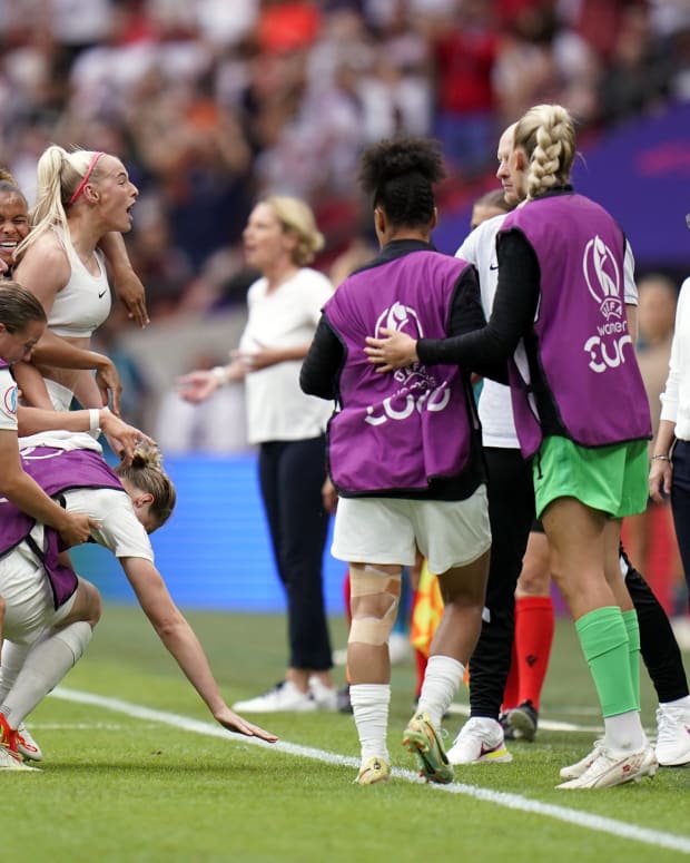 England coach Sarina Wiegman pictured (right) staying calm while her players celebrate Chloe Kelly's goal against Germany in the final of Euro 2022