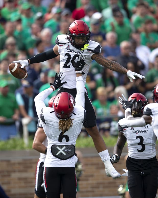 Cincinnati Bearcats linebacker Deshawn Pace (20) is lifted by Cincinnati Bearcats safety Bryan Cook (6) after intercepting a pass in the first half of the NCAA football game between the Cincinnati Bearcats and the Notre Dame Fighting Irish on Saturday, Oct. 2, 2021, at Notre Dame Stadium in South Bend, Ind. Cincinnati Bearcats At Notre Dame Fighting Irish 187