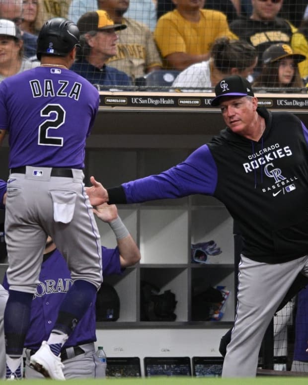 Aug 3, 2022; San Diego, California, USA; Colorado Rockies center fielder Yonathan Daza (2) is congratulated at the dugout after scoring a run on a sacrifice fly hit by designated hitter Charlie Blackmon (not pictured) during the fourth inning at Petco Park. Mandatory Credit: Orlando Ramirez-USA TODAY Sports