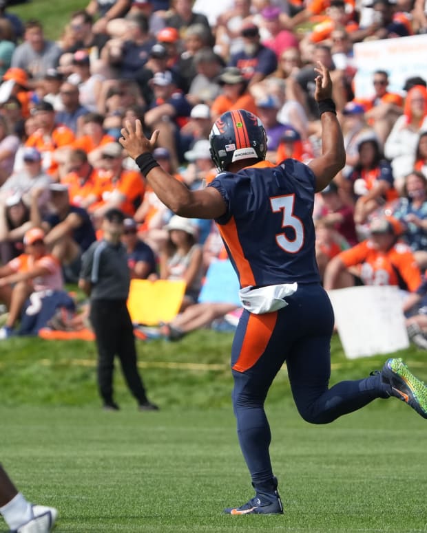 Denver Broncos quarterback Russell Wilson (3) reacts toward the fans during training camp at the UCHealth Training Center.