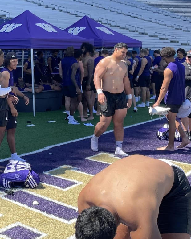 The Huskies cool off in ice baths set up on the field.