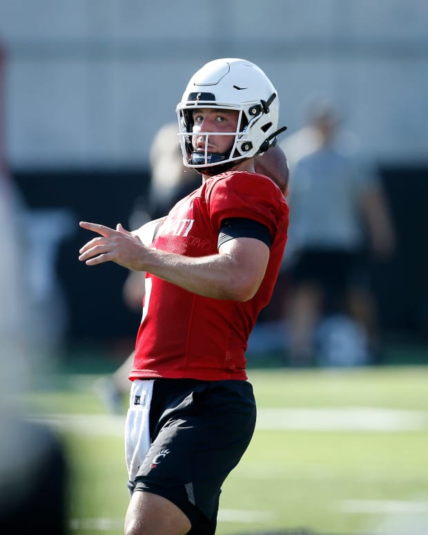 Bearcats quarterback Ben Bryant (6) drops back to throw during the first day of preseason training camp at the University of Cincinnati s Sheakley Athletic Complex in Cincinnati on Wednesday, Aug. 3, 2022. Bearcats Football Camp