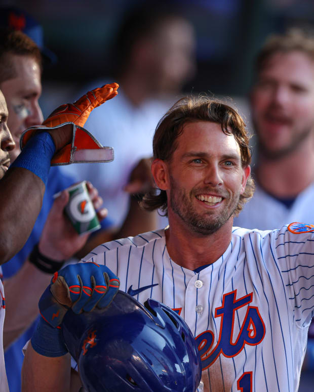Aug 7, 2022; New York City, New York, USA; New York Mets second baseman Jeff McNeil (1) celebrates with teammates after scoring a run on a wild pitch during the fifth inning against the Atlanta Braves at Citi Field.
