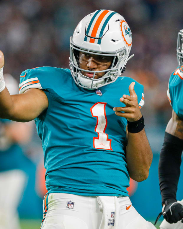 Jan 9, 2022; Miami Gardens, Florida, USA; Miami Dolphins quarterback Tua Tagovailoa (1) reacts with wide receiver Jaylen Waddle (17) after running with the football for a first down against the New England Patriots during the fourth quarter at Hard Rock Stadium. Mandatory Credit: Sam Navarro-USA TODAY Sports