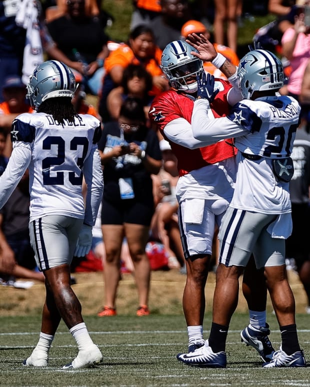 Dallas Cowboys quarterback Dak Prescott (4) with running back Tony Pollard (20) during a joint training camp with the Denver Broncos at the UCHealth Training Center.
