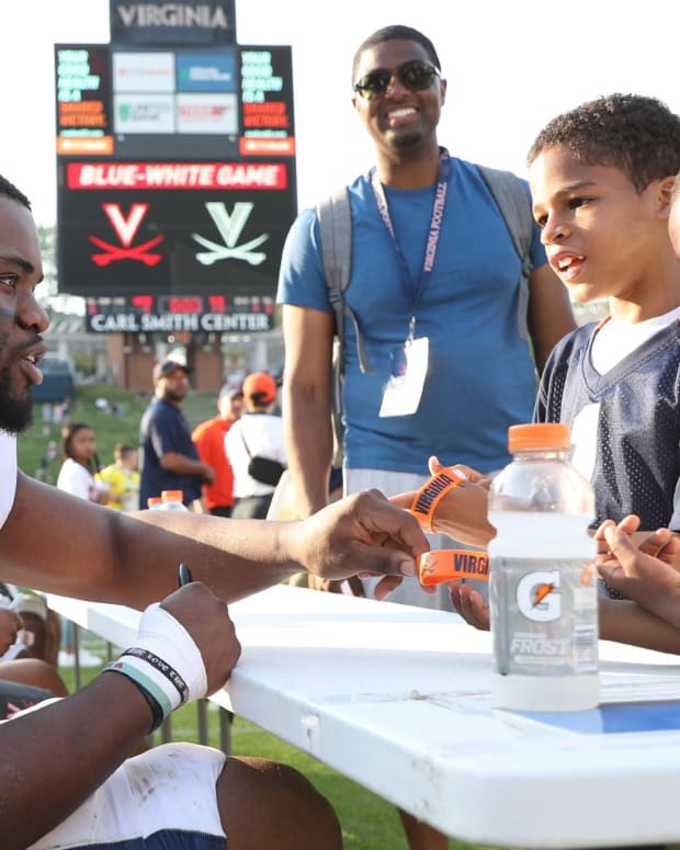 Virginia running back Mike Hollins meets fans after the UVA spring game.