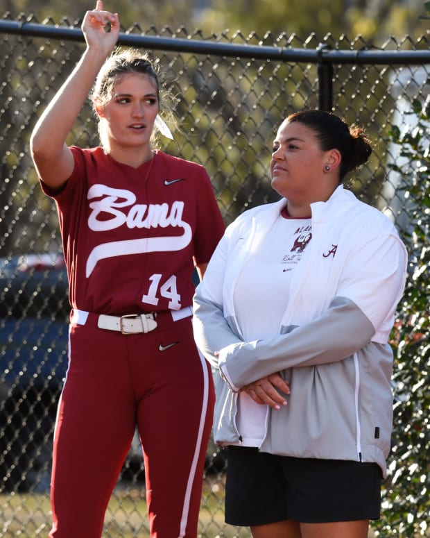 Alabama pitcher Montana Fouts talks with pitching coach Stephanie VanBrakle Prothro in the bullpen before the game with Florida State on March 16, 2022.