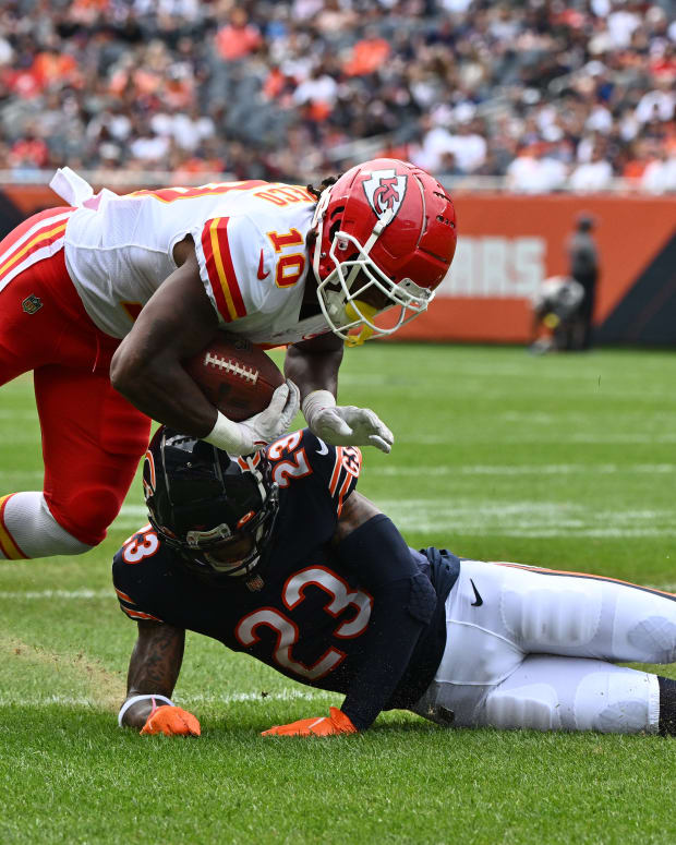 Aug 13, 2022; Chicago, Illinois, USA; Kansas City Chiefs running back Isiah Pacheco (10) is taken down by Chicago Bears defensive back Lamar Jackson (23) in the first quarter at Soldier Field. Mandatory Credit: Jamie Sabau-USA TODAY Sports