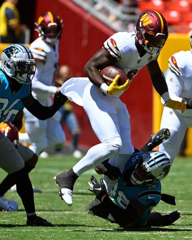Washington Commanders running back Brian Robinson (8) carries the ball against the Carolina Panthers on Saturday during the first half at FedExField.