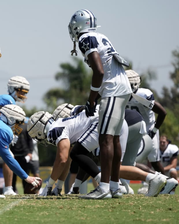 Aug 17, 2022; Costa Mesa, CA, USA; A general overall view of the line of scrimmage as players wear Guardian helmet caps as Los Angeles Chargers center Will Clapp (76) snaps the ball against the Dallas Cowboys during joint practice at Jack Hammett Sports Complex. Mandatory Credit: Kirby Lee-USA TODAY Sports