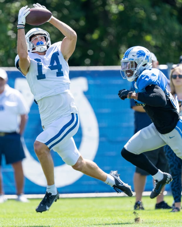 Indianapolis Colts wide receiver Alec Pierce (14) jumps for a reception as he works against a Detroit Lions defender during training camp Wednesday, Aug. 17, 2022, at Grand Park in Westfield, Ind.