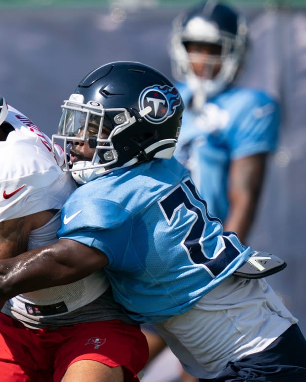 Tennessee Titans cornerback Roger McCreary (21) breaks up a pass intended for Tampa Bay Buccaneers wide receiver Jerreth Sterns (9) during a joint training camp practice at Ascension Saint Thomas Sports Park Thursday, Aug. 18, 2022, in Nashville, Tenn.