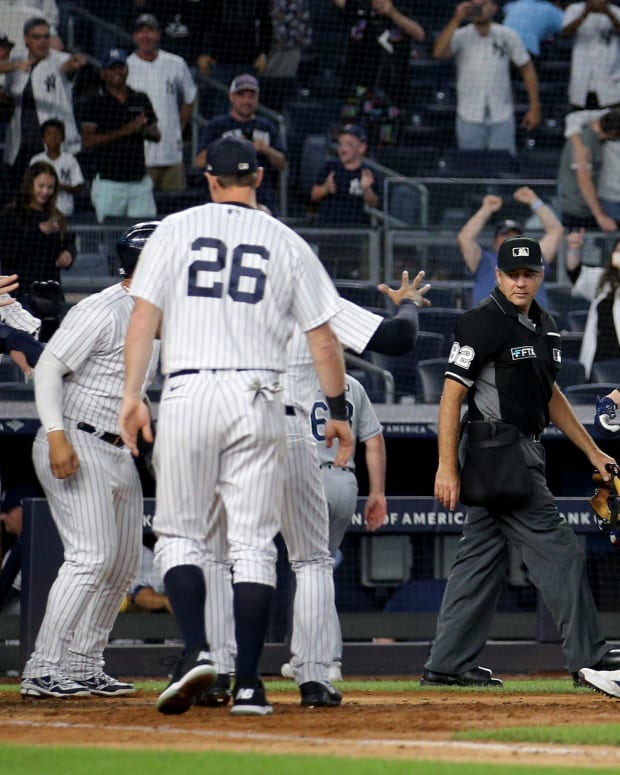 Aug 17, 2022; Bronx, New York, USA; New York Yankees designated hitter Josh Donaldson (28) is met at home by teammates after hitting a game winning grand slam home run against the Tampa Bay Rays during the tenth inning at Yankee Stadium. Mandatory Credit: Brad Penner-USA TODAY Sports