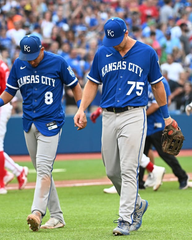 Jul 16, 2022; Toronto, Ontario, CAN; Kansas City Royals third baseman Nicky Lopez (8) and left fielder Brewer Hicklen (75) walk off the field as the Toronto Blue Jays celebrate a victory in the 10th inning at Rogers Centre. Mandatory Credit: Dan Hamilton-USA TODAY Sports