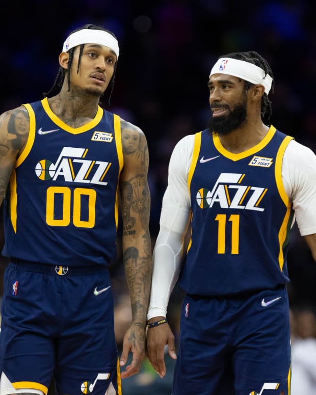 Utah Jazz guards Jordan Clarkson (00) and Mike Conley (11) talk during a timeout in the third quarter against the Philadelphia 76ers at Wells Fargo Center.