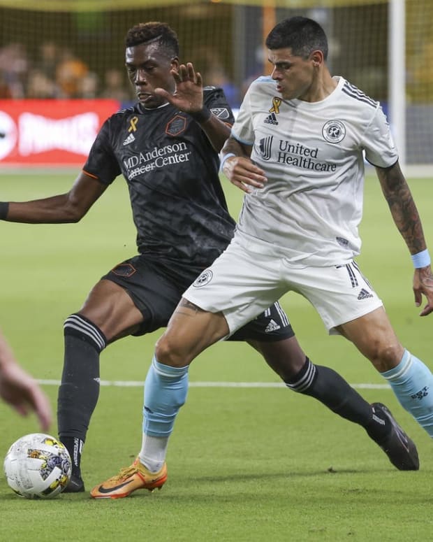 Sep 13, 2022; Houston, Texas, USA; Houston Dynamo FC defender Teenage Hadebe (17) and New England Revolution forward Gustavo Bou (7) battle for the ball during the first half at PNC Stadium. Mandatory Credit: Troy Taormina-USA TODAY Sports