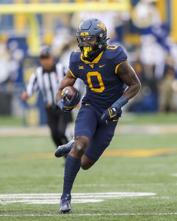 Nov 20, 2021; Morgantown, West Virginia, USA; West Virginia Mountaineers wide receiver Bryce Ford-Wheaton (0) makes a catch and runs for extra yards during the first quarter against the Texas Longhorns at Mountaineer Field at Milan Puskar Stadium.