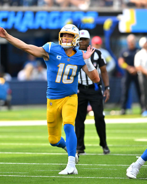 Sep 11, 2022; Inglewood, California, USA; Los Angeles Chargers quarterback Justin Herbert (10) as he throws a touchdown pass to Los Angeles Chargers wide receiver DeAndre Carter (not pictured) in the second quarter against the Las Vegas Raiders at SoFi Stadium. Mandatory Credit: Jayne Kamin-Oncea-USA TODAY Sports