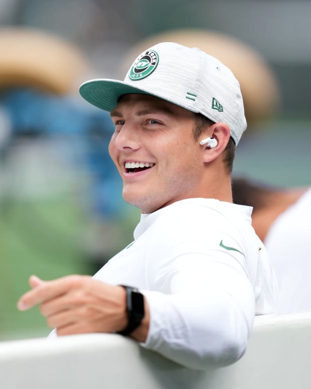 New York Jets QB Zach Wilson smiling on bench