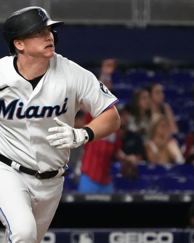 Sep 20, 2022; Miami, Florida, USA; Miami Marlins designated hitter Garrett Cooper (26) runs to first base after hitting a double in the ninth inning against the Chicago Cubs at loanDepot park. Mandatory Credit: Jasen Vinlove-USA TODAY Sports