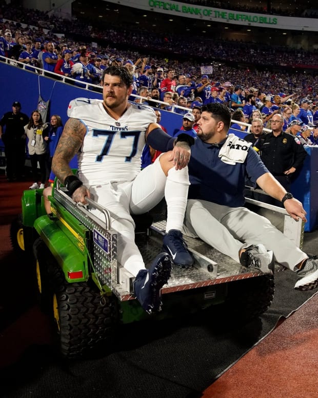 Tennessee Titans offensive tackle Taylor Lewan (77) is helped from the field after getting hurt during the first quarter against the Buffalo Bills at Highmark Stadium Monday, Sept. 19, 2022, in Orchard Park, New York.