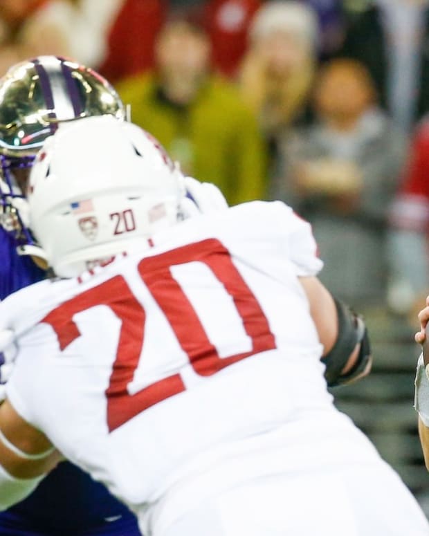 Quinn Roff (20) shared in the last sack of a Husky quarterback, in this case Sam Huard.