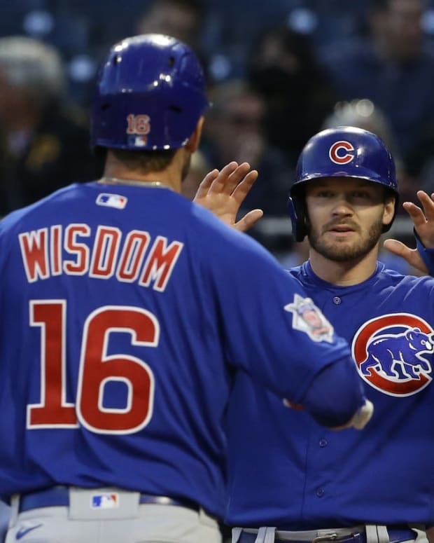 Sep 23, 2022; Pittsburgh, Pennsylvania, USA; Chicago Cubs left fielder Ian Happ (right) greets right fielder Patrick Wisdom (16) crossing home plate after hitting a two-run home run against the Pittsburgh Pirates during the second inning at PNC Park. Mandatory Credit: Charles LeClaire-USA TODAY Sports