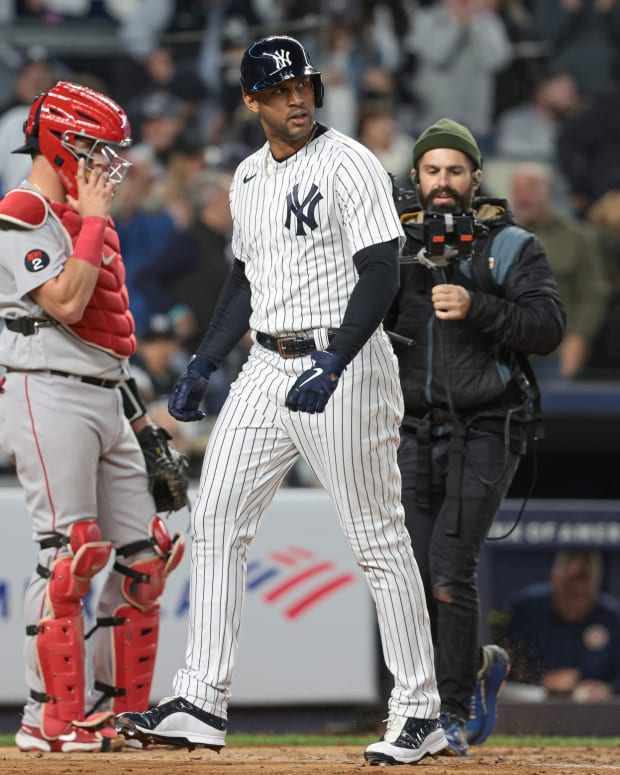 New York Yankees OF Aaron Hicks touches home plate on home run