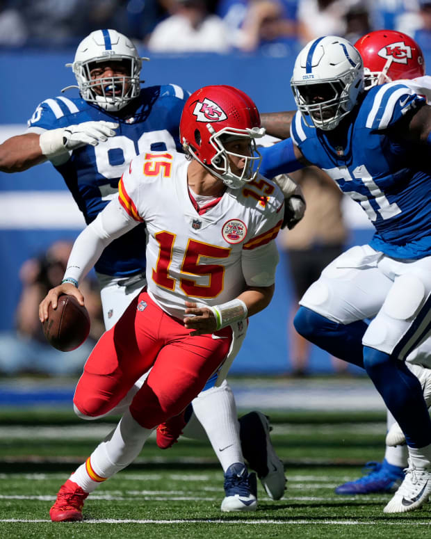 Sep 25, 2022; Indianapolis, Indiana, USA; Kansas City Chiefs quarterback Patrick Mahomes (15) scrambles out of the pocket while being pressured by Indianapolis Colts defenders during a game at Lucas Oil Stadium. Mandatory Credit: Robert Scheer/IndyStar Staff-USA TODAY Sports