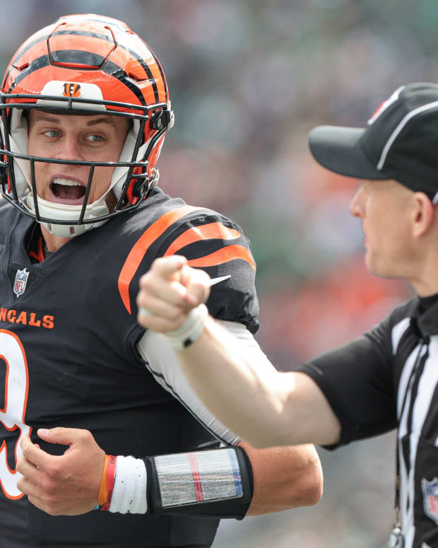 Sep 25, 2022; East Rutherford, New Jersey, USA; Cincinnati Bengals quarterback Joe Burrow (9) talks with side judge Jonah Monroe (120) during the first half against the New York Jets at MetLife Stadium. Mandatory Credit: Vincent Carchietta-USA TODAY Sports