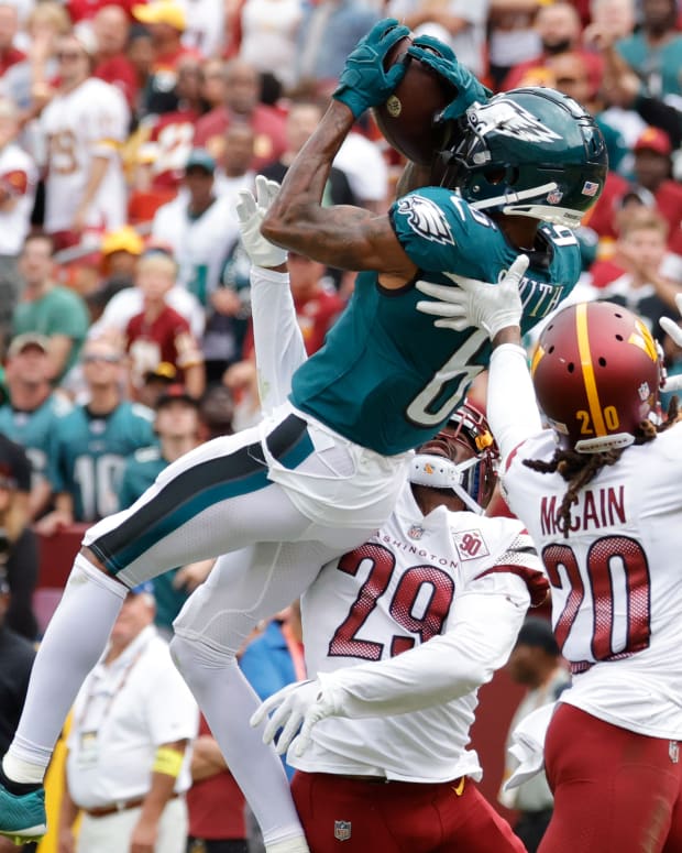 Sep 25, 2022; Landover, Maryland, USA; Philadelphia Eagles wide receiver DeVonta Smith (6) catches a pass over Washington Commanders cornerback Kendall Fuller (29) and Commanders safety Bobby McCain (20) during the second quarter at FedExField. Mandatory Credit: Geoff Burke-USA TODAY Sports