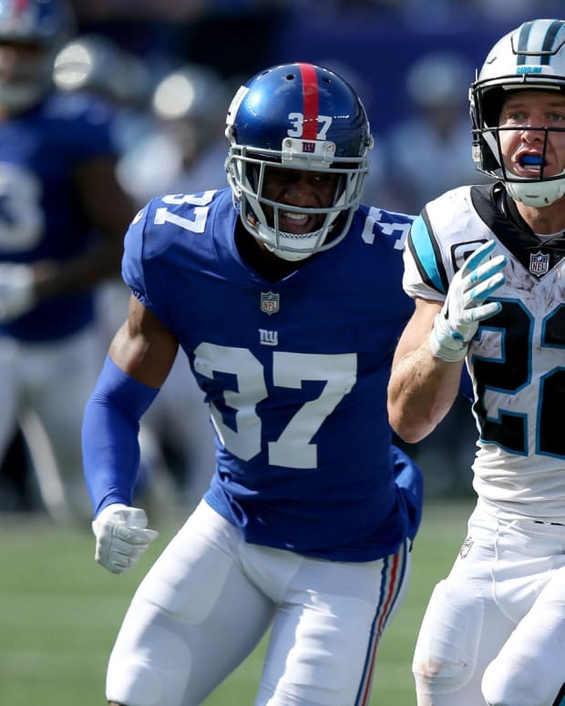 Sep 18, 2022; East Rutherford, New Jersey, USA; Carolina Panthers running back Christian McCaffrey (22) runs with the ball against New York Giants defensive back Fabian Moreau (37) during the fourth quarter at MetLife Stadium.