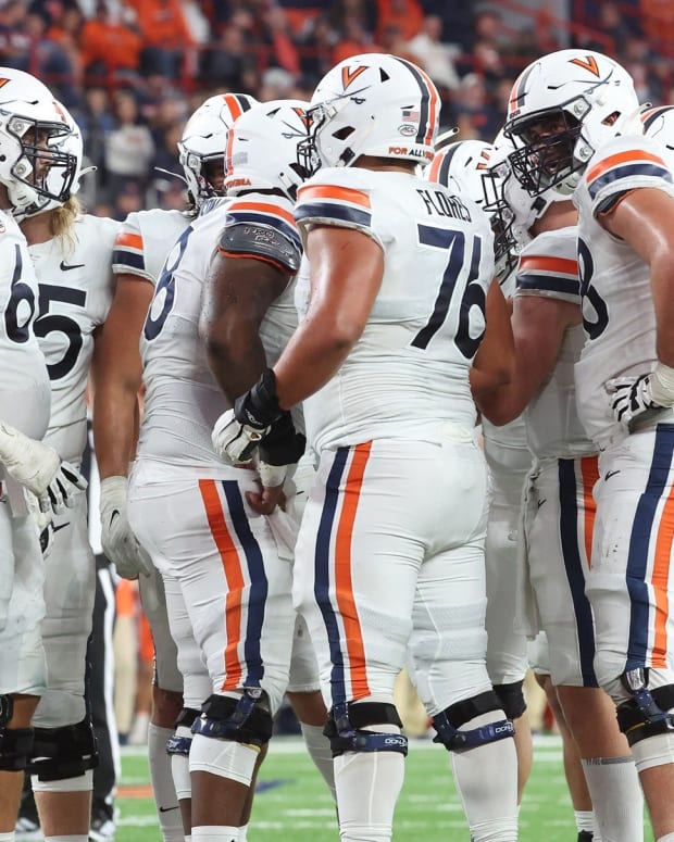 The Virginia Cavaliers offense huddles before a play during the game at Syracuse.