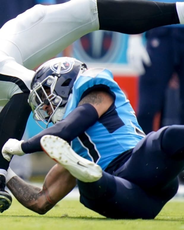 Las Vegas Raiders tight end Foster Moreau (87) is tackled by Tennessee Titans safety Amani Hooker (37) during the second quarter at Nissan Stadium Sunday, Sept. 25, 2022, in Nashville, Tenn.
